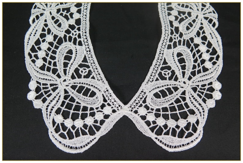 May include: White lace collar with a delicate floral pattern and beaded accents. The collar is designed for sewing onto a garment.