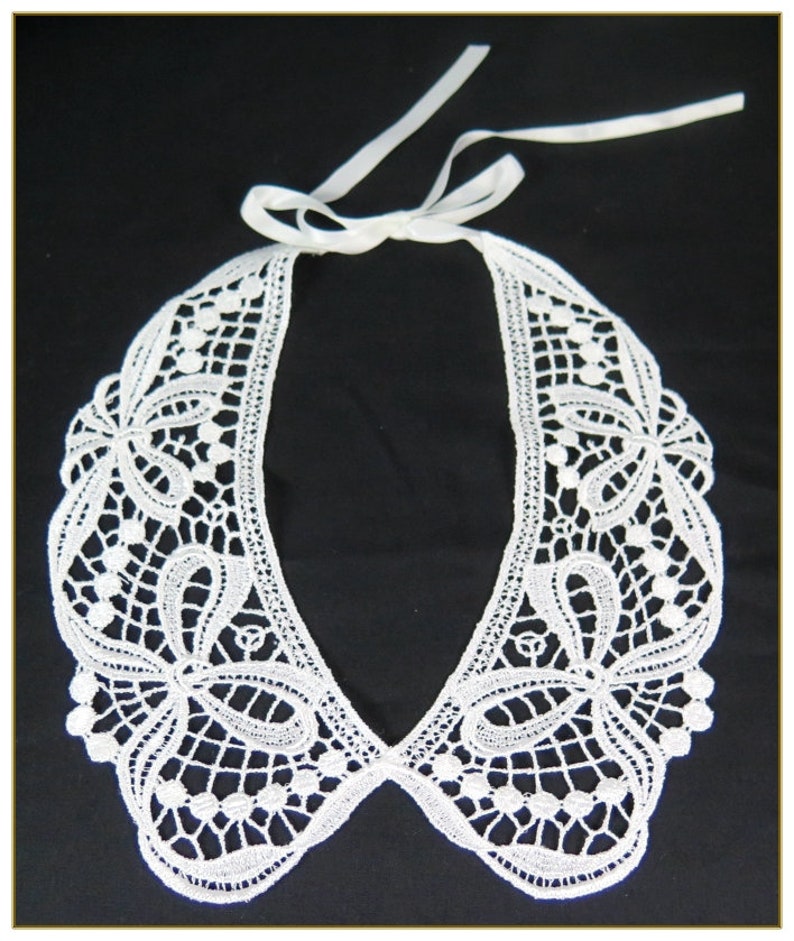 May include: White lace collar with a delicate floral pattern and a ribbon tie.
