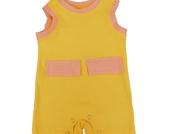 May include: A sleeveless yellow baby onesie with pink trim and two pockets. The onesie has snap closures at the bottom.