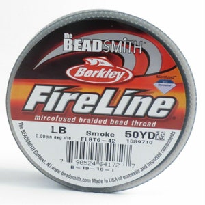 May include: A spool of "FireLine" microfused braided bead thread by The Beadsmith. The label is red, orange, and white, with the brand name "Berkley" and "FireLine" prominently displayed. The thread is "Smoke" color, 0.006in avg. dia, and 50 yards.