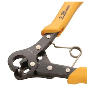 May include: Close-up of a black and yellow tool with the text "2.25 mm" on the yellow handle. The tool has a spring and a curved cutting edge. The word "PATENTED" is printed on the tool.