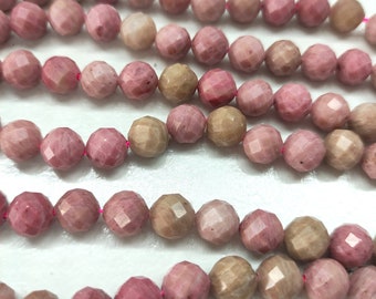May include: A strand of pink and brown faceted gemstone beads. The beads are strung on a pink thread.