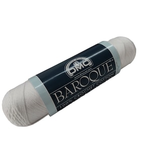 May include: A white skein of DMC Baroque crochet cotton yarn. The label reads "Creative World DMC www.dmcusa.com Baroque 100% Crochet Cotton Made in Egypt."