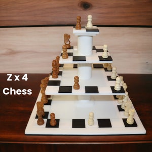 May include: A tiered chess set with white and black squares, featuring brown and white chess pieces. The set has a cylindrical support structure and the text "Z x 4 Chess" in the lower left corner.