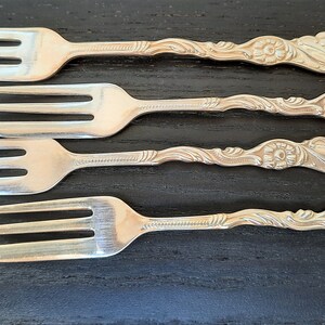 A 99 boxed set of 6 chrome plate on nickel silver pastry cake forks