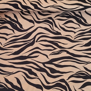 May include: Beige fabric with a black tiger stripe pattern.
