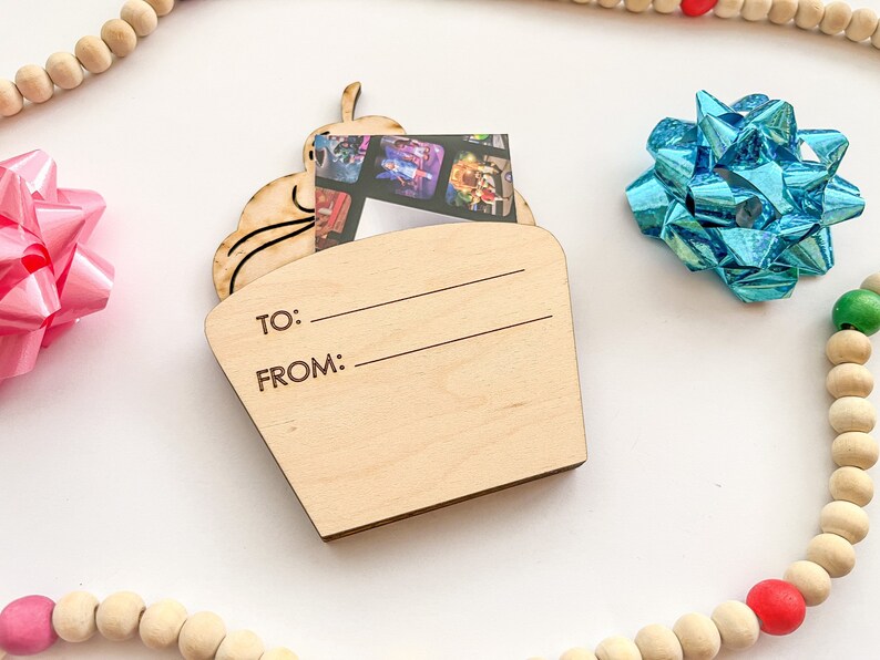 May include: A wooden cupcake-shaped gift tag with a photo insert and space to write "To:" and "From:".