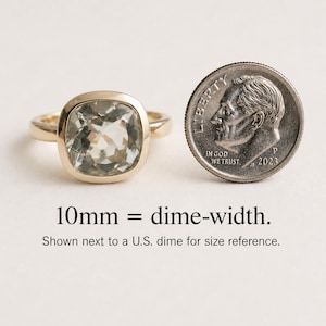 May include: A gold ring with a square, light green gemstone. Next to the ring is a U.S. dime for size comparison. The text on the image reads "10mm = dime-width."