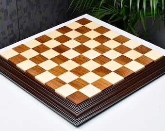 May include: A wooden chessboard with a dark brown frame. The board has alternating light and dark squares.