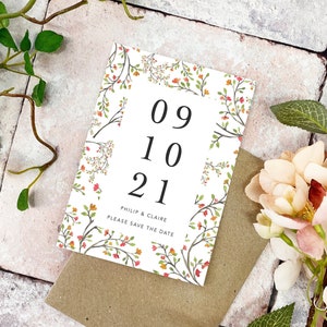 May include: Save the date card with a floral design in shades of orange, red, and green. The card features the date "09 10 21" and the names "Philip & Claire".
