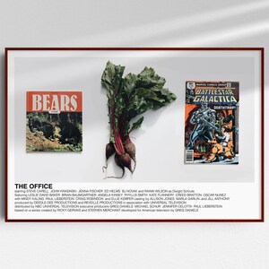 May include: A framed print of a scene from the TV show "The Office". The print features a comic book, a bunch of beets, and a magazine cover with the word "Bears" on it. The print also includes the title "The Office" and a list of the show's cast and crew.