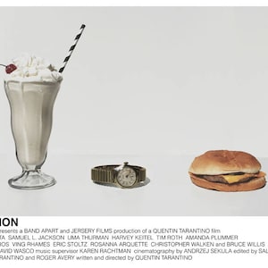 May include: A movie poster for Pulp Fiction, a Quentin Tarantino film. The poster features a milkshake, a hamburger, and a wristwatch on a white background. The title "Pulp Fiction" is written in black text at the bottom of the poster.