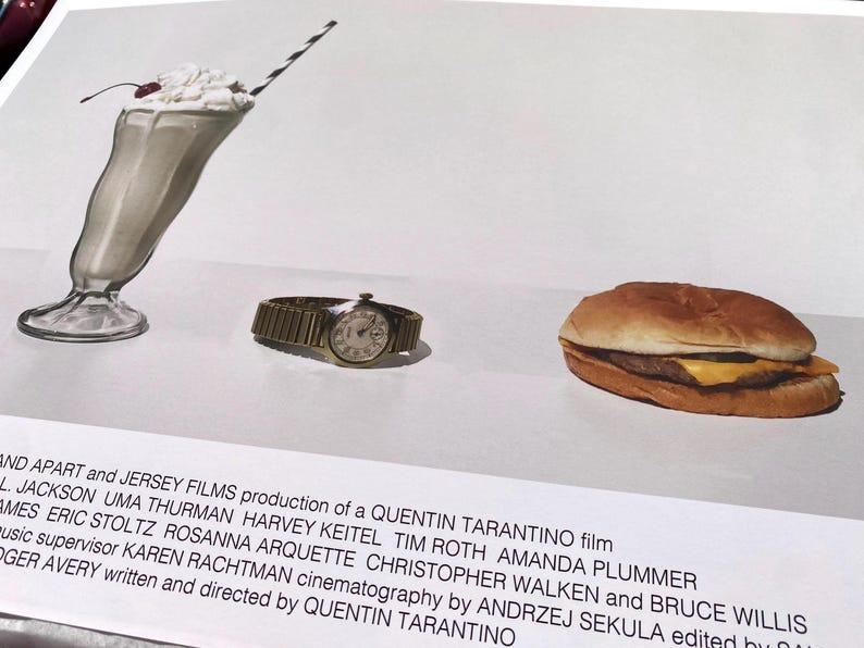 May include: A still life image of a milkshake, a wristwatch, and a hamburger. The milkshake is in a tall glass with a cherry on top and a striped straw. The wristwatch is gold with a white face. The hamburger is on a white plate. The image is a promotional poster for the film Pulp Fiction.