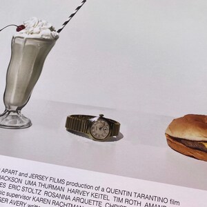 May include: A movie poster for the film "Pulp Fiction" featuring a milkshake, a hamburger, and a wristwatch. The poster text reads "Presents a Band Apart and Jersey Films production of a Quentin Tarantino film".