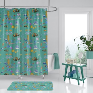May include: A teal shower curtain with a colorful fish and seahorse pattern. The shower curtain is hung on a silver shower rod. A matching bath mat is on the floor. The bathroom has a white bathtub, a green stool with towels, and a plant in a green pot.