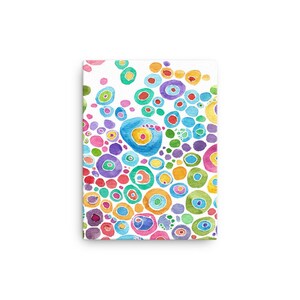 May include: A canvas print featuring a watercolor painting of colorful, concentric circles. The circles vary in size and color, including blue, green, yellow, red, and purple, against a white background. The artwork has a modern, abstract style.