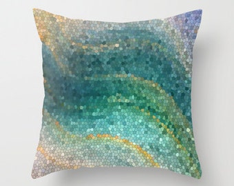 May include: A decorative throw pillow with a mosaic pattern in shades of blue, green, and gold. The pillow has a square shape and a soft, textured fabric.
