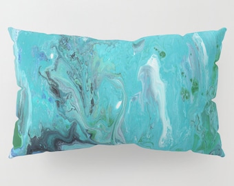 May include: A turquoise blue throw pillow with a marbled pattern in shades of blue, green, and white.