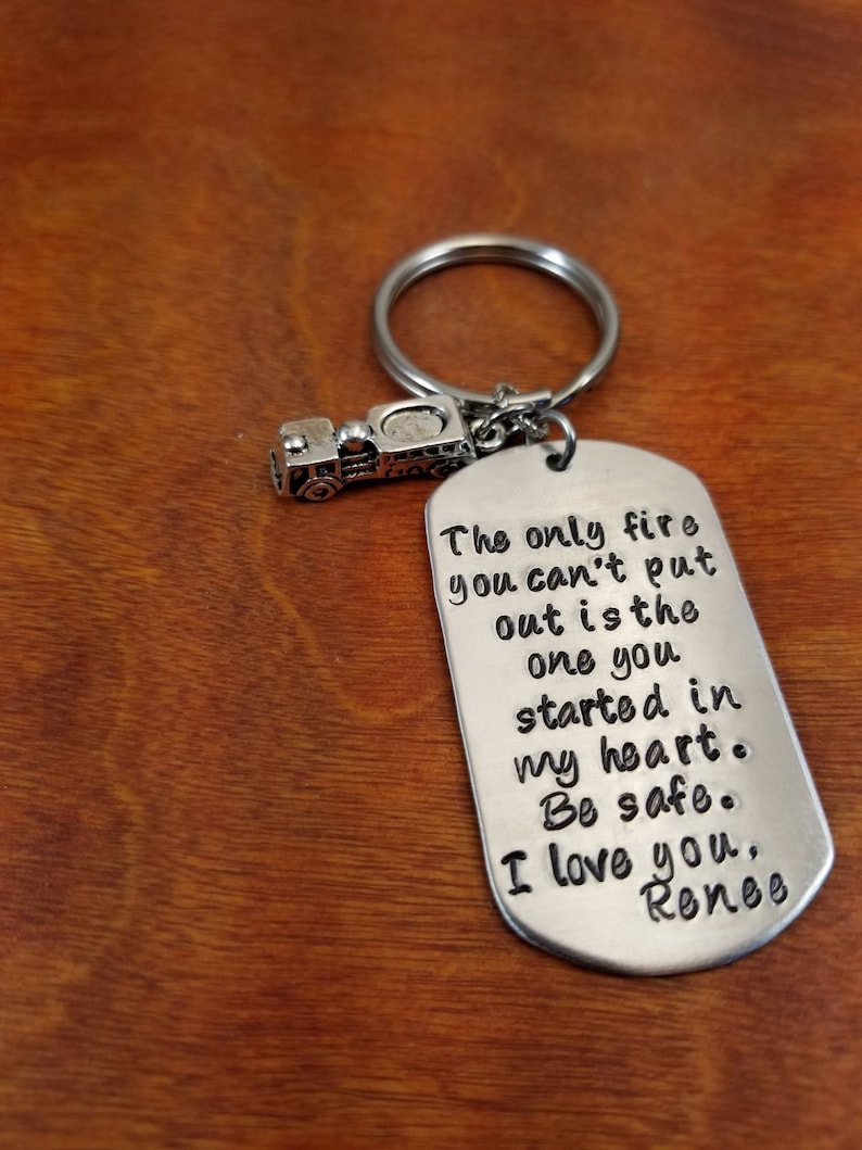 May include: Silver keychain with a small fire truck charm and a tag that reads "The only fire you can't put out is the one you started in my heart. Be safe. I love you, Renee."