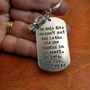 May include: Silver keychain with a truck charm and a tag that reads "The only fire you can't put out is the one you started in my heart. Be safe. I love you. Renee"