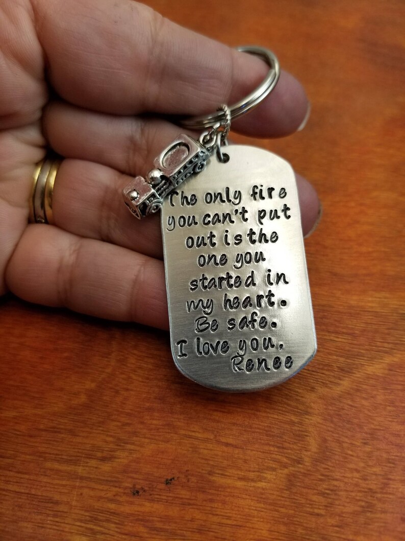 May include: Silver keychain with a truck charm and a tag that reads "The only fire you can't put out is the one you started in my heart. Be safe. I love you. Renee"