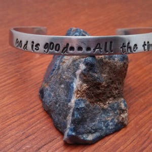 May include: Silver bracelet with the inscription "God is good...All the time!"