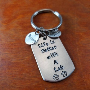 May include: Silver keychain with a dog paw print charm and the text "Life is Better with a Lab".