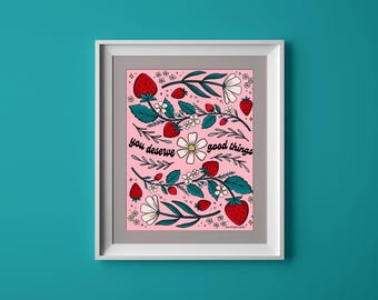 May include: Pink floral print with strawberries and the text "you deserve good things" on a white frame.