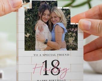 May include: A custom building block photo display featuring a photograph of two friends embracing. The white block structure includes the printed text TO A SPECIAL FRIEND, the number 18, the name Hailey in pink script, and HAPPY BIRTHDAY.