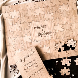 Alternative wedding guest book with this personalised wood puzzle guestbook. This rustic wedding décor feature custom jigsaw pieces, wedding table décor. Wedding sign and dried confetti, this wooden guest book is made by Secret Creation Ltd.