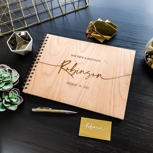 Alternative wedding guest book with this personalized wood engraved guestbook. This rustic wedding décor feature a custom wooden guestbook, and wedding table décor. Wedding sign and confetti, this wedding planner book is from Secret Creation Ltd
