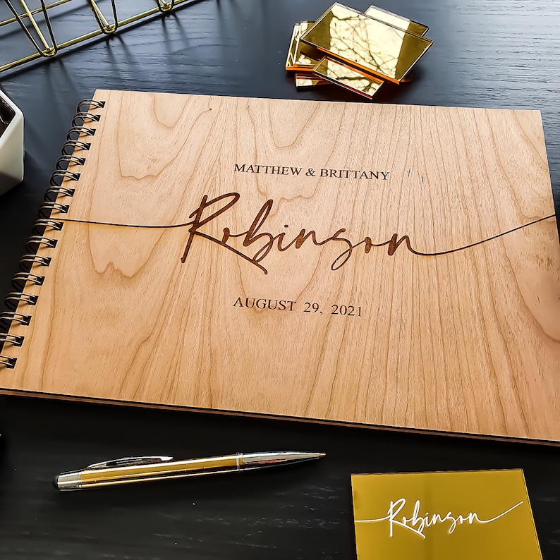 Alternative wedding guest book with this personalized wood engraved guestbook. This rustic wedding décor feature a custom wooden guestbook, and wedding table décor. Wedding sign and confetti, this wedding planner book is from Secret Creation Ltd