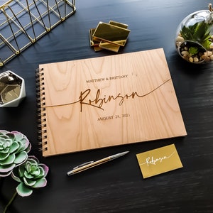 Alternative wedding guest book with this personalized wood engraved guestbook. This rustic wedding décor feature a custom wooden guestbook, and wedding table décor. Wedding sign and confetti, this wedding planner book is from Secret Creation Ltd