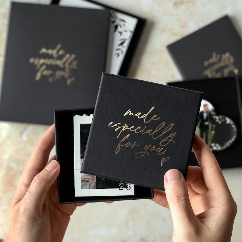 A person's hands holding a black box with gold text that says "made especially for you".