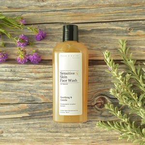 May include: A clear plastic bottle of Face n Earth Skin Care Sensitive Skin Face Wash with a black cap. The white label features the text Sensitive Skin Face Wash, All Natural, Soothing & Gentle, Chamomile & Cucumber Extracts, and 10 fl oz 300 ml.