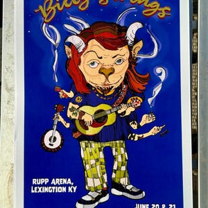 May include: Poster for the Blue Grass Goat Billy Strings concert. The poster features a cartoon illustration of a goat-like figure playing multiple instruments. The poster is blue with gold and white text. The concert is at Rupp Arena, Lexington KY, June 20 & 21, 2025.