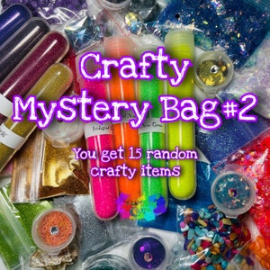 May include: A variety of craft supplies in a mystery bag. The bag includes 15 random items, such as glitter, sequins, and beads. The text on the image reads "Crafty Mystery Bag #2 You get 15 random crafty items".
