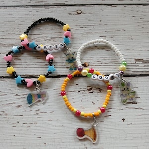 Dandy’s World inspired bracelet with Charms, Yatta and party hat trinket, Looey and blow horn trinket Roblox Inspired, hand drawn charms
