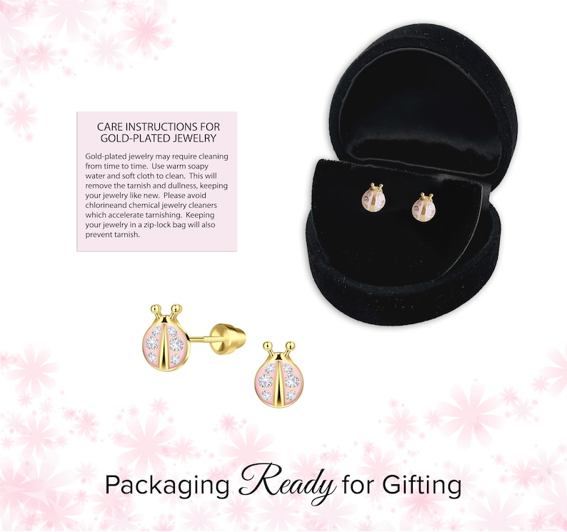 May include: Gold-plated ladybug stud earrings with pink enamel and clear crystal accents. The earrings are displayed in a black velvet jewelry box. The image also includes care instructions for gold-plated jewelry and the text "Packaging Ready for Gifting."