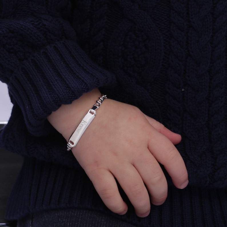 Baby boy wearing sterling silver customized ID bracelet.