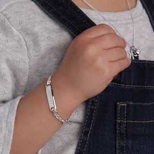 Little girl wearing personalized sterling silver ID bracelet.
