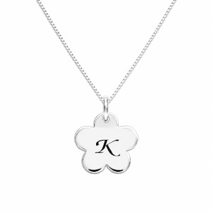 May include: A silver-toned necklace featuring a delicate box chain and a polished flower-shaped pendant. The center of the smooth, five-petaled floral charm is engraved with the uppercase letter K in a classic, elegant serif typeface.