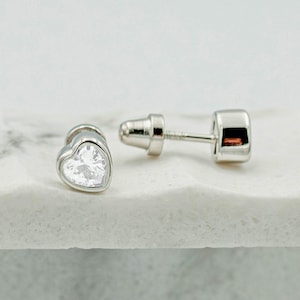 May include: A rustic wooden sign with the text "Welcome to our home" in white lettering. The sign features a distressed finish and a simple, inviting design, perfect for front door decor.