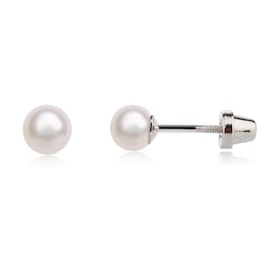 May include: A pair of pearl stud earrings with silver posts and backs.
