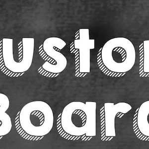 May include: A chalkboard-style graphic with the words "CUSTOM BOARD" in bold, white, outlined letters. The letters have a shadow effect, and the background is a dark gray color.