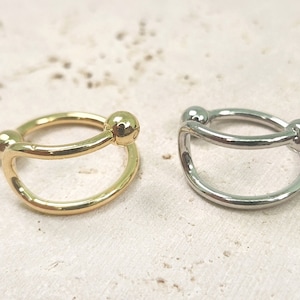 May include: Two hoop earrings with a curved bar design. One earring is gold and the other is silver.