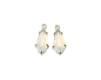May include: Two gold teardrop-shaped pendants with clear opal stones.
