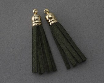 May include: Two dark green suede tassels with gold metal tops.