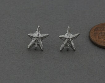 May include: A pair of silver starfish earrings. The earrings are small and delicate, and they would make a great gift for someone who loves the ocean.