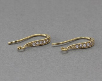 May include: A pair of gold-tone earring hooks with a row of clear cubic zirconia stones.